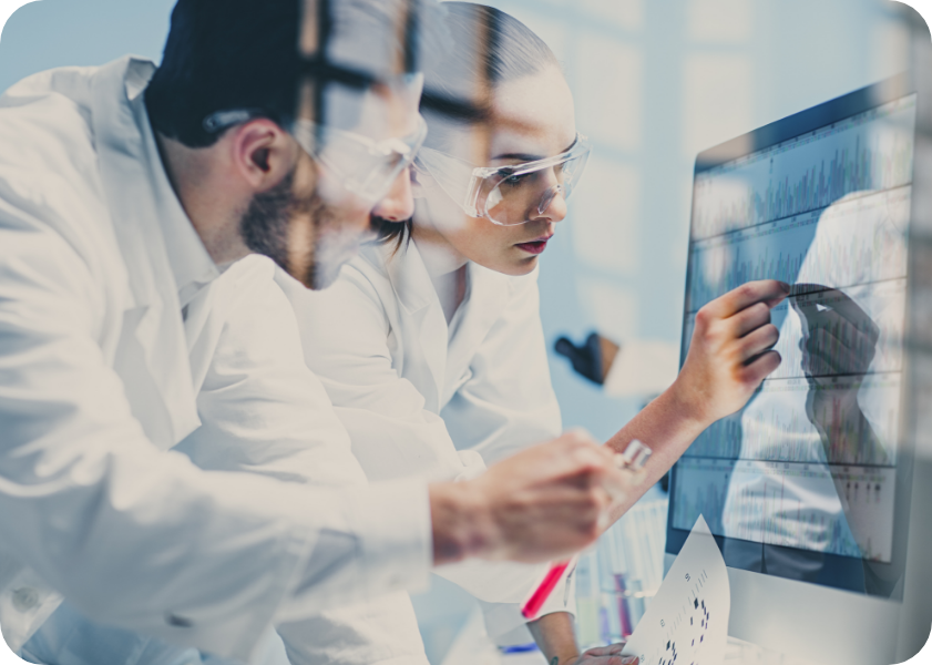 Man and woman in safety goggles at a lab